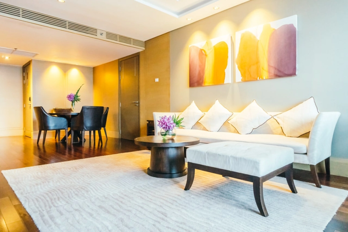 Sleek duct fan coil unit from the HPL series installed in a modern living room setting.