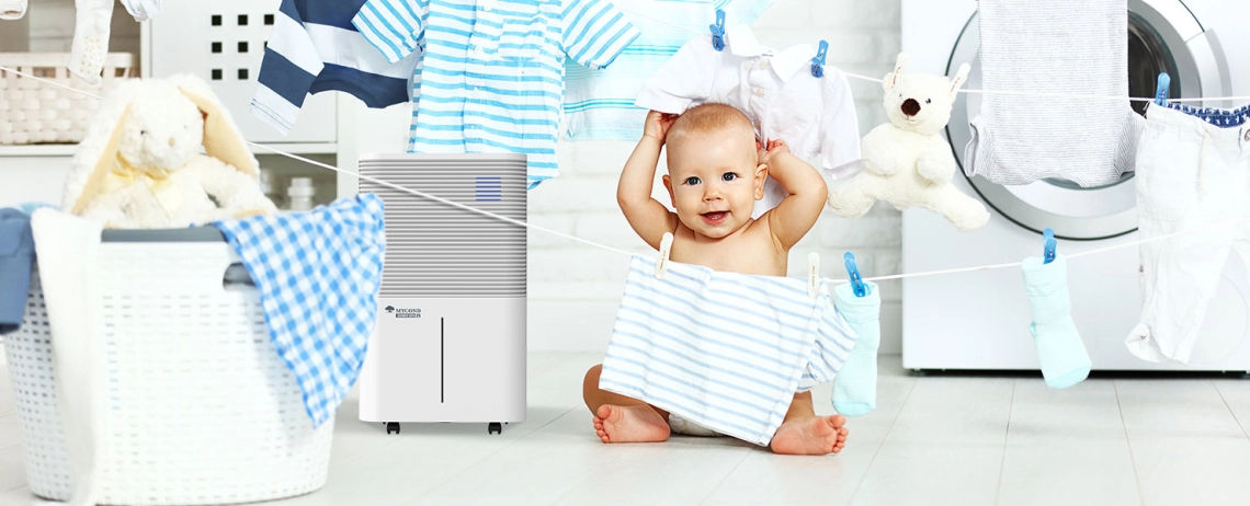 A small child in the bathroom with the Roomer Hepa 25 air dehumidifier.