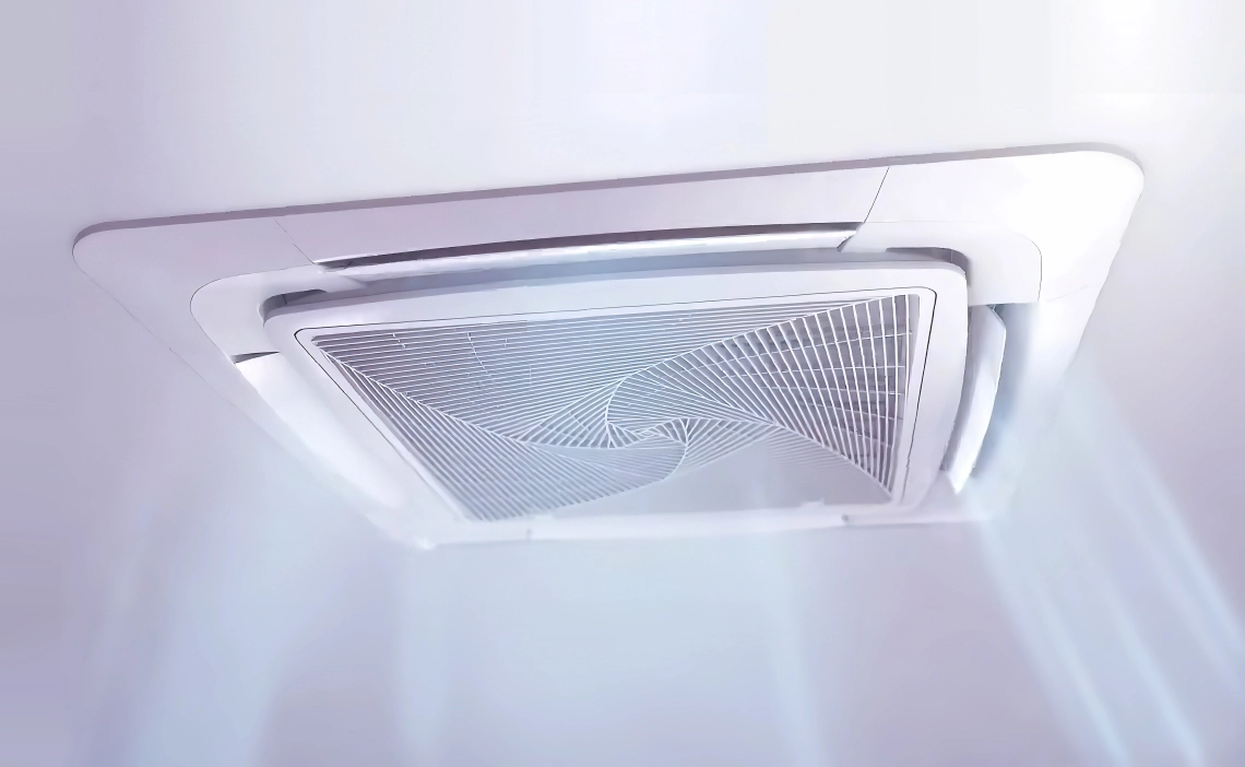 A ceiling cassette air conditioning unit with round-way airflow for efficient cooling.