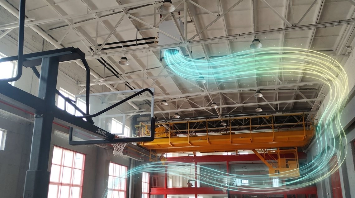 Mycond OXA side discharge unit in a sports arena with an overhead crane